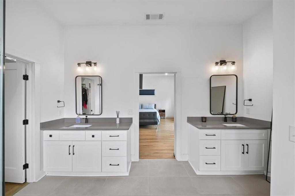 1846 Rogers Avenue Southwest Atlanta, GA 30310 - Photo 25 of 46 a bathroom with a double vanity sink and mirror