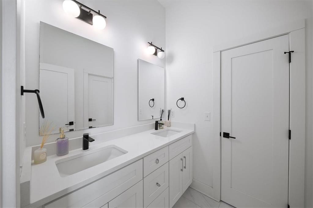 1846 Rogers Avenue Southwest Atlanta, GA 30310 - Photo 29 of 46 a bathroom with double vanity sink a mirror and shower