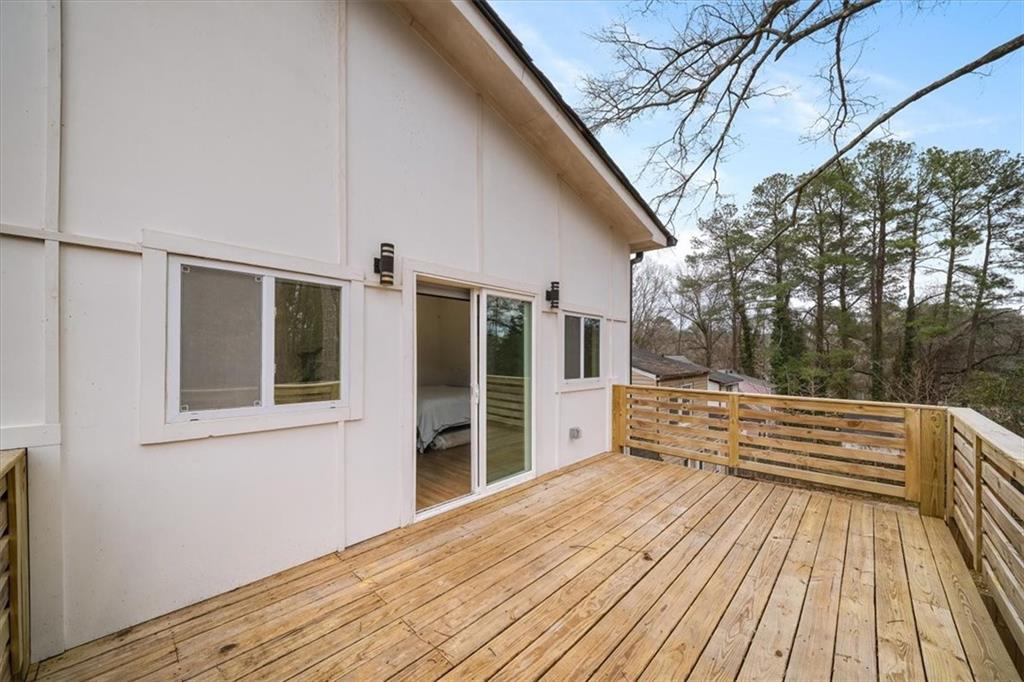 1846 Rogers Avenue Southwest Atlanta, GA 30310 - Photo 8 of 46 a view of a roof deck with wooden floor and fence next to a yard