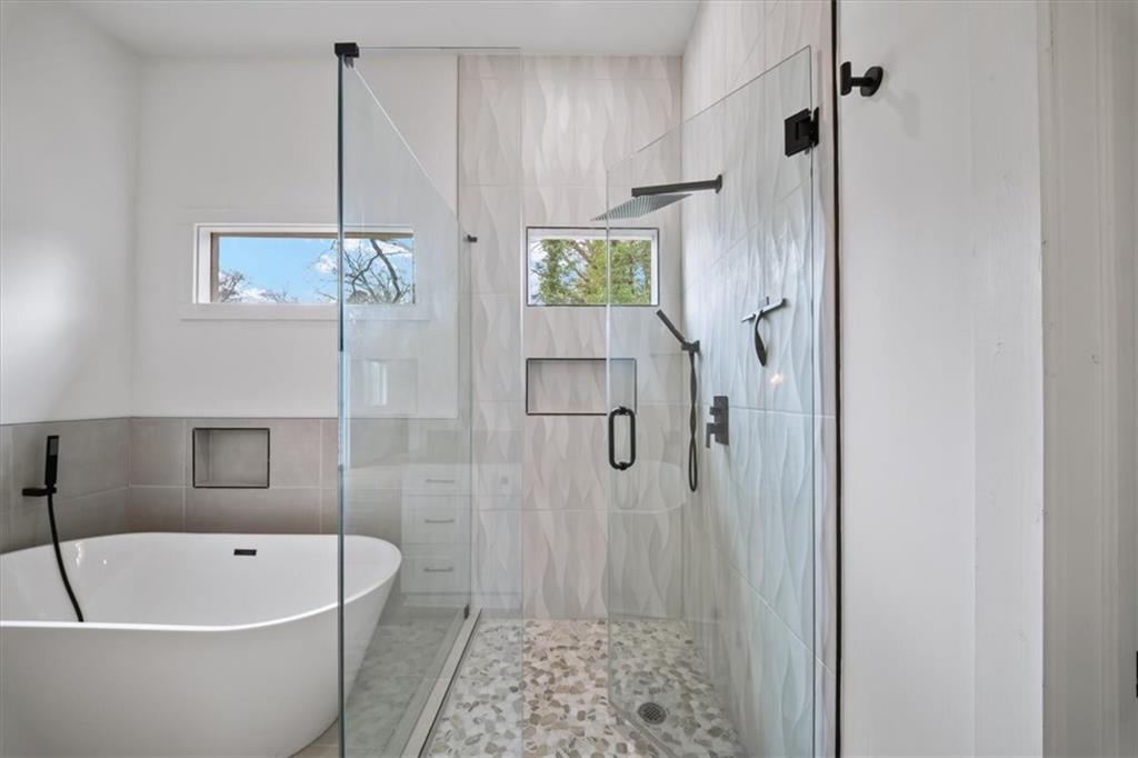 1846 Rogers Avenue Southwest Atlanta, GA 30310 - Photo 9 of 46 a bathroom with a bathtub a window and a shower