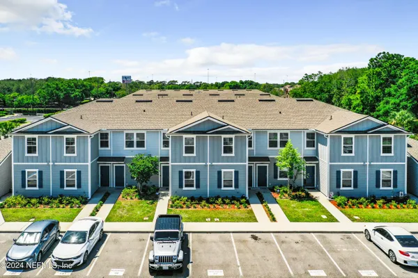 a aerial view of a house with a yard table and chairs