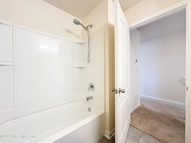 a bathroom with a sink a toilet and shower curtain