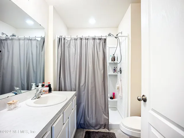 a bathroom with double vanity sink and mirror
