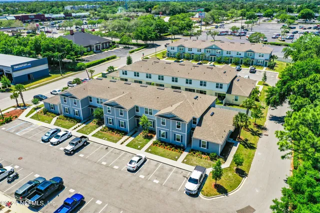 an aerial view of a house with a big yard