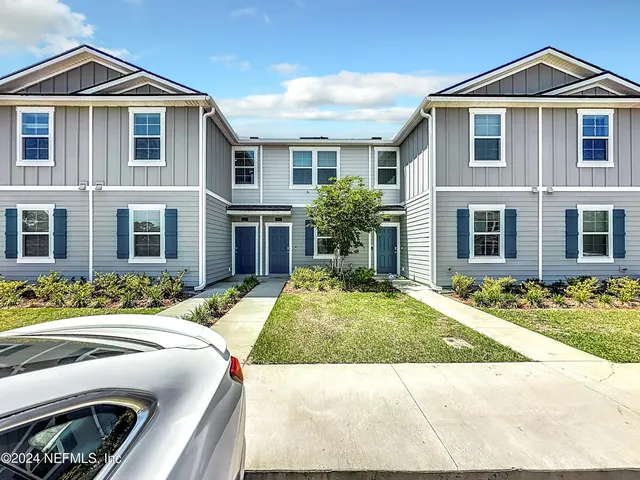 an aerial view of a swimming pool with seating space