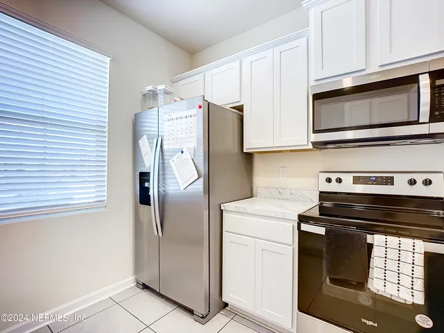 a kitchen with appliances and cabinets
