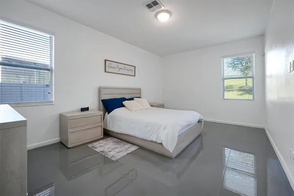 a bedroom with a bed and a couch