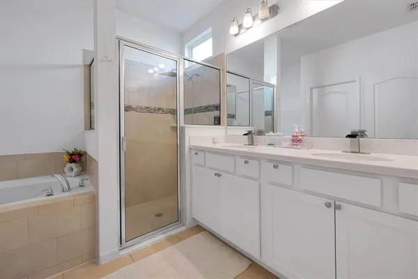 a bathroom with a tub sink and mirror