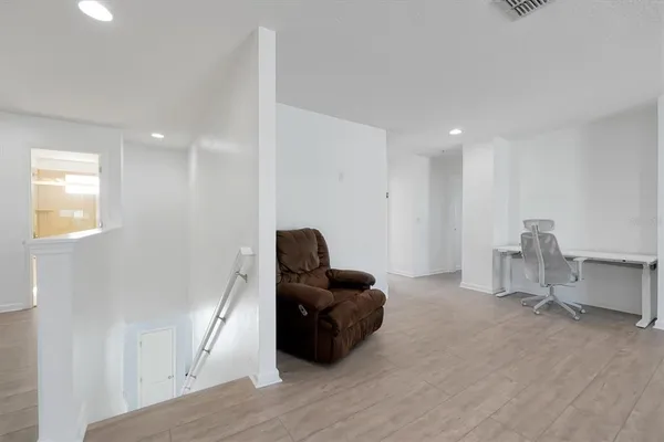 a living room with furniture and a mirror