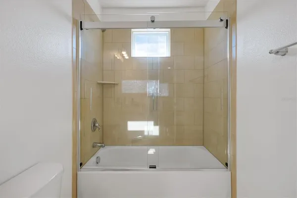 a bathroom with a tub and shower