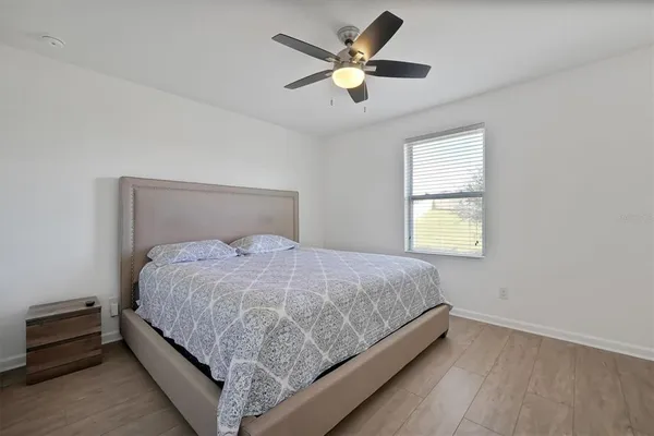 a bedroom with a bed and window