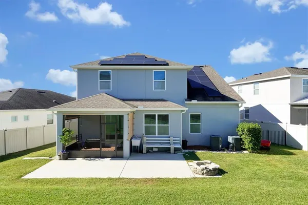 a view of a house with a backyard porch and sitting area