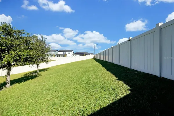 a view of a backyard of the house