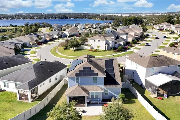 an aerial view of a house with swimming pool and ocean view