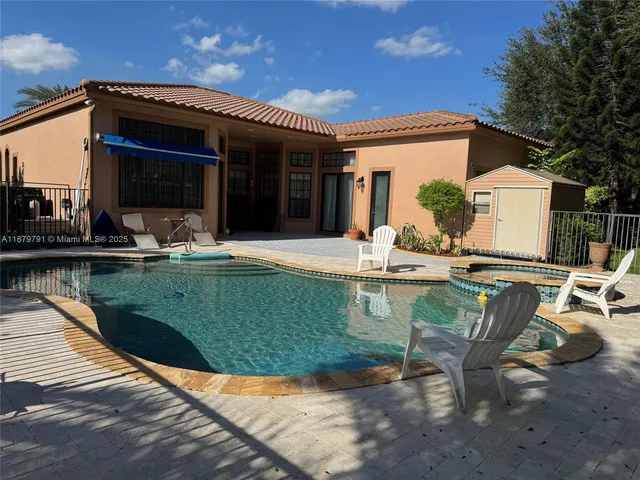 a view of house with yard outdoor seating area and furniture