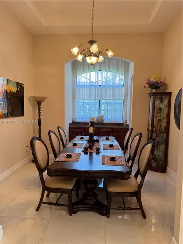 a kitchen with stainless steel appliances kitchen island granite countertop a refrigerator and a sink