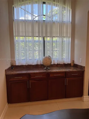 a kitchen with stainless steel appliances granite countertop a refrigerator stove and sink