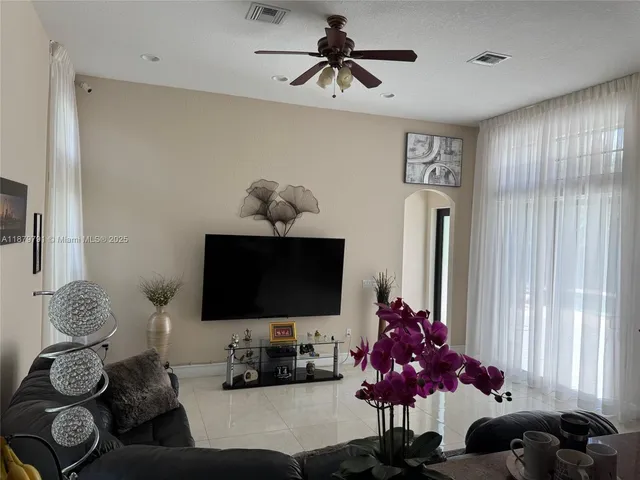 a bathroom with a tub a sink and a large mirror