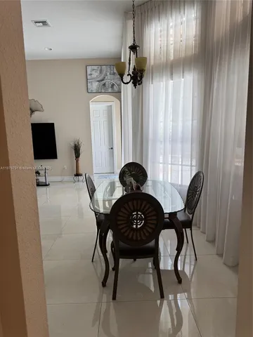 a bedroom with a bed and a television