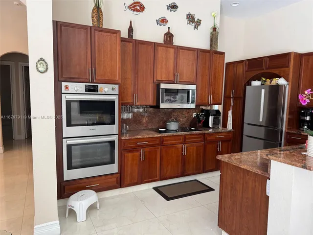 a bedroom with a balcony a bed and a window