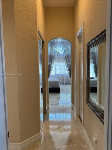 a view of a hallway view with wooden floor and living room