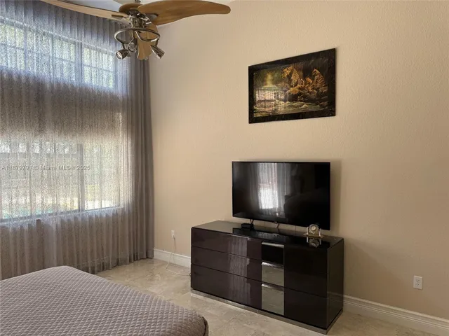 a front view of a house with plants