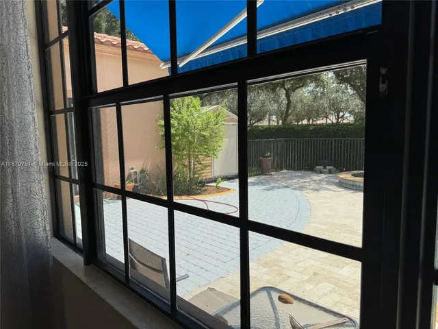a view of a house with backyard and sitting area