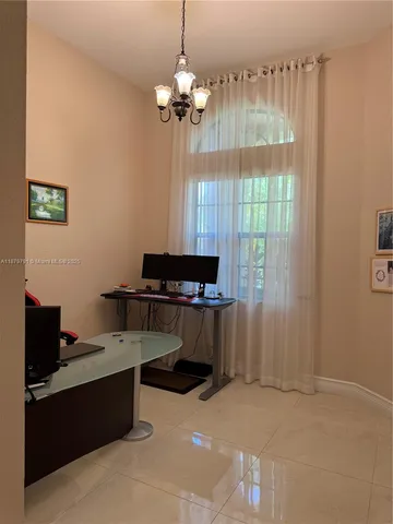 a view of a backyard with plants and large trees