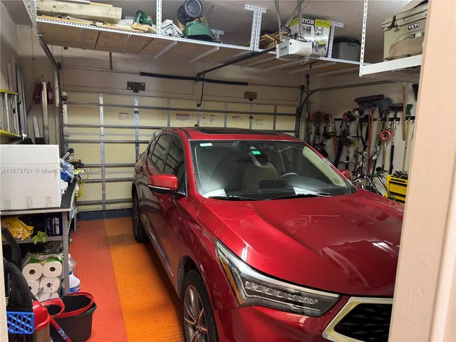 a view of a street with a building and palm trees