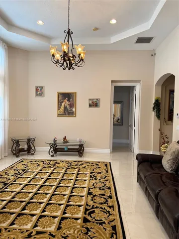 a kitchen with stainless steel appliances kitchen island granite countertop a sink stove and refrigerator