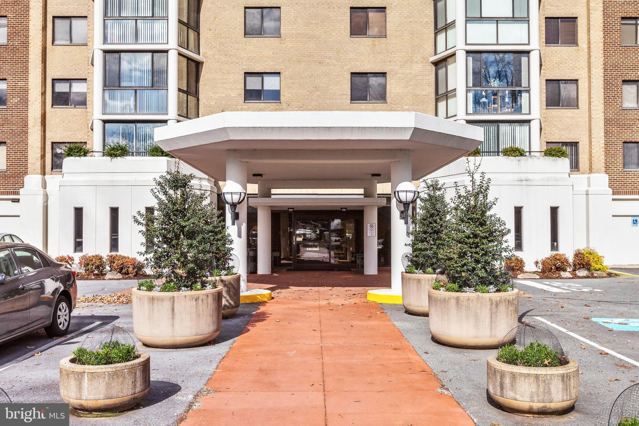 15107 Interlachen Drive, Unit 21025 Silver Spring, MD 20906 - Photo 1 of 38 a view of a building with potted plants