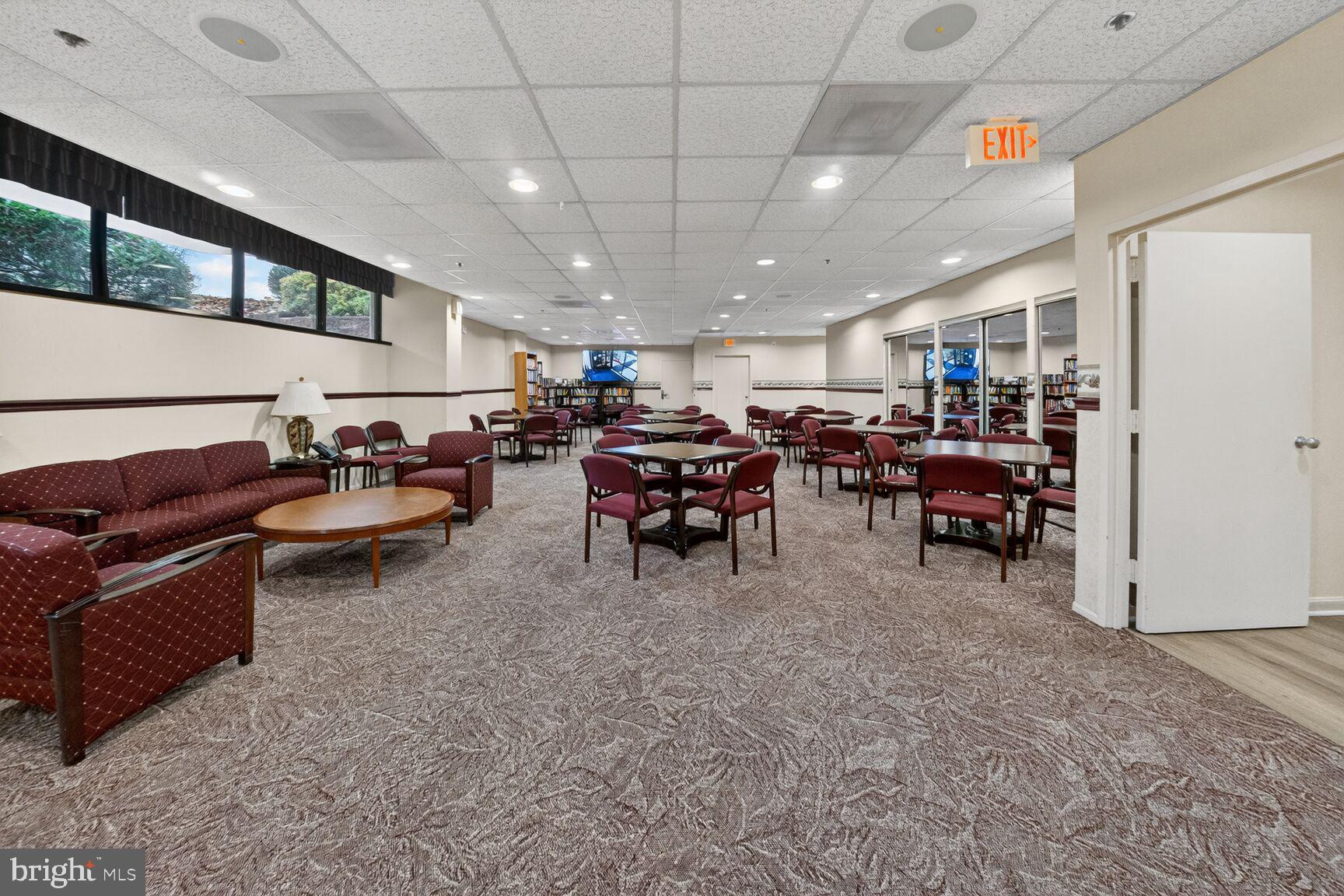15107 Interlachen Drive, Unit 21025 Silver Spring, MD 20906 - Photo 26 of 38 a living room with lots of furniture and a chandelier
