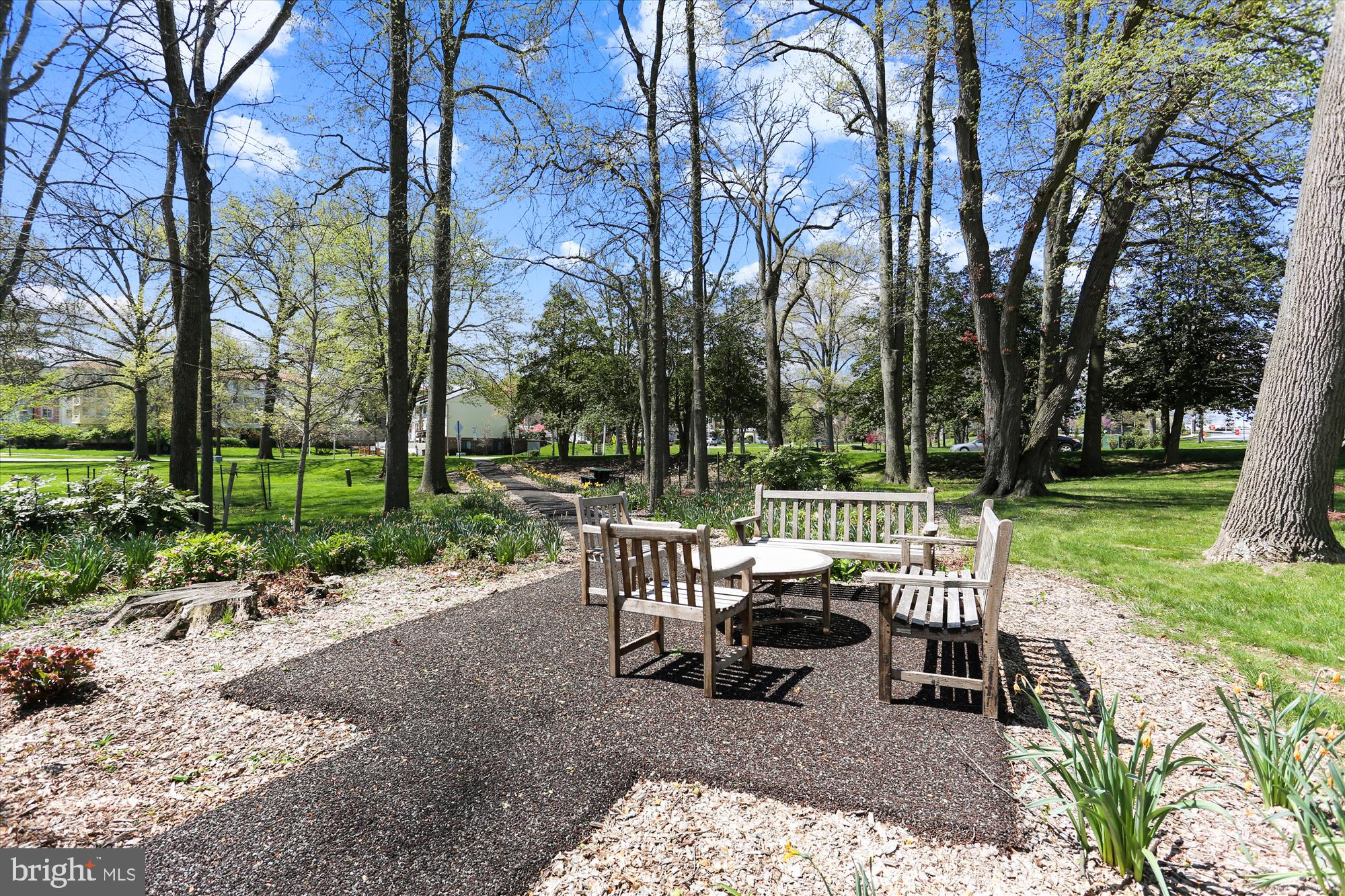 15107 Interlachen Drive, Unit 21025 Silver Spring, MD 20906 - Photo 36 of 38 a view of a table and chairs in the garden
