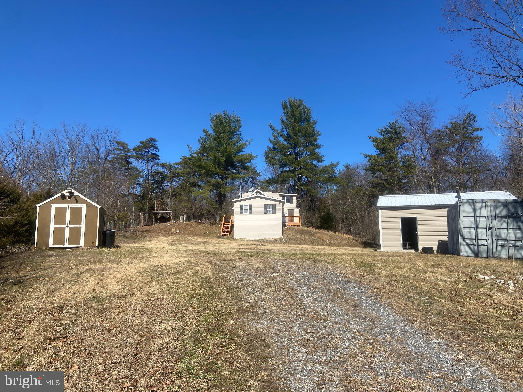 31207 Gold Plains Road Southeast Little Orleans, MD 21766 - Photo 5 of 96 a front view of a house with a yard and garage