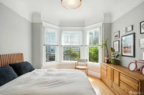a bedroom with a bed and a chandelier