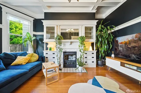 a view of a dining room with furniture a chandelier and wooden floor