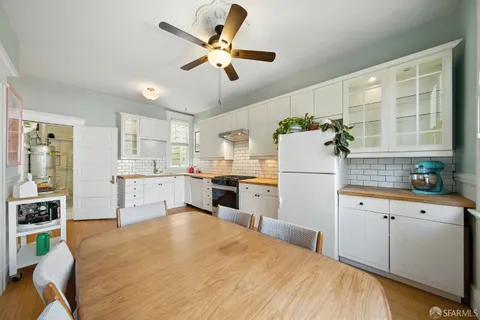 a view of a patio with a table and chairs and plants