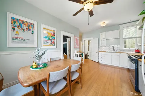 a view of a backyard with table and chairs potted plants and a fire pit