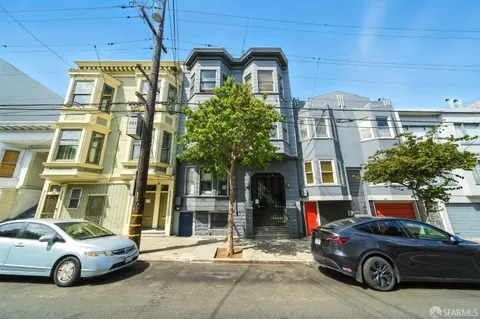 an aerial view of multiple houses with yard
