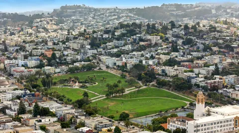 a view of a cafe with a couple of people seating