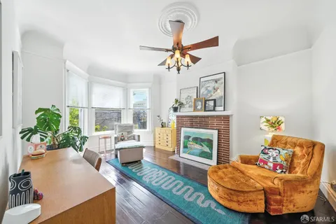 a living room with furniture and a potted plant