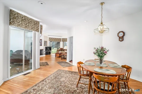 a view of a dining room with furniture and chandelier