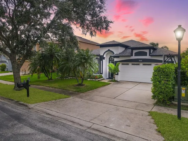 a front view of a house with a yard and a garage
