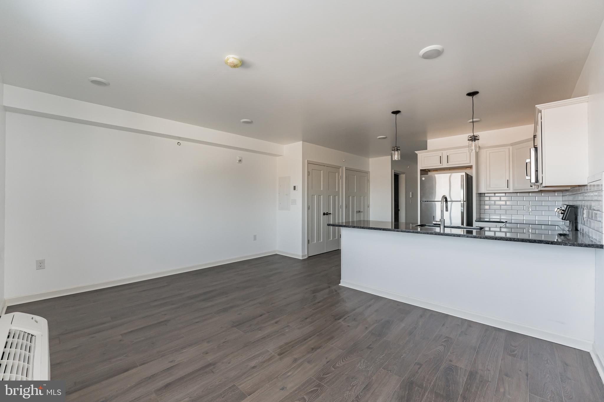6649 Ridge Avenue, Unit A407 Philadelphia, PA 19128 - Photo 4 of 7 a view of a kitchen with wooden floor