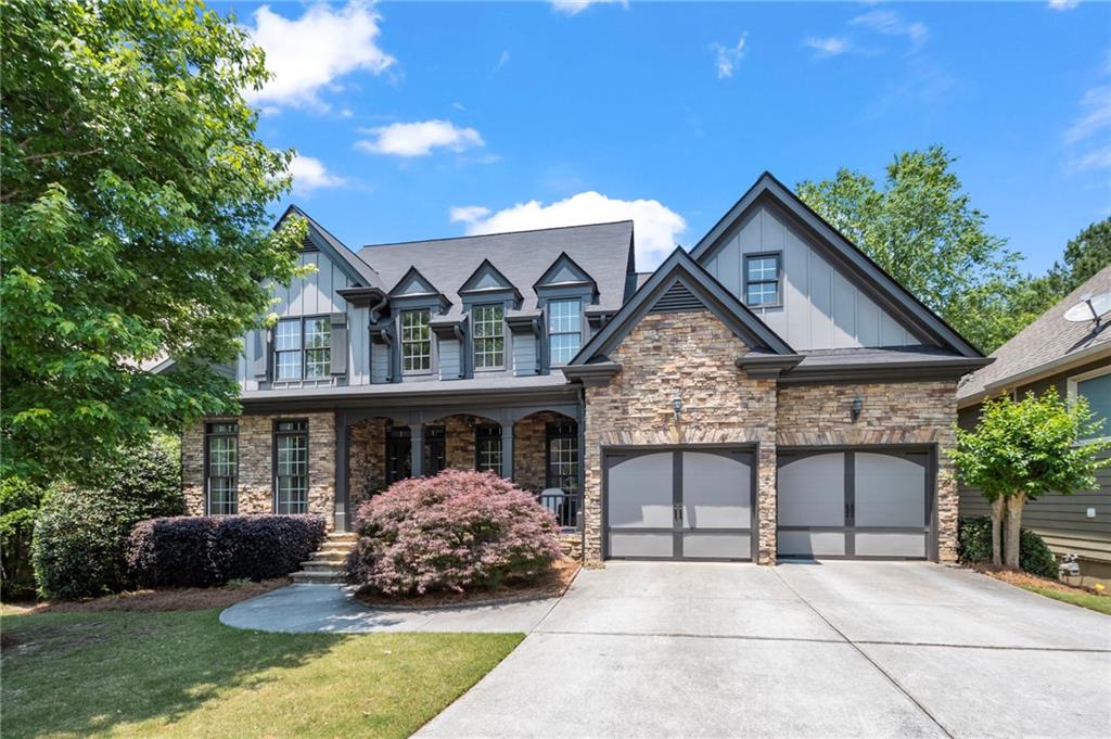 a front view of a house with a garden and plants