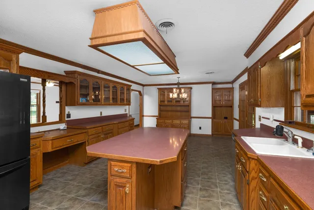 a kitchen with a stove a sink and a refrigerator