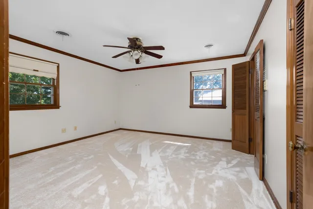 a view of a livingroom with a ceiling fan and window