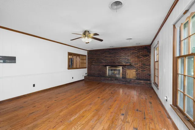 a view of a room with wooden floor and fireplace