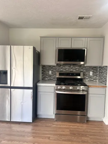 a kitchen with a stove and a microwave