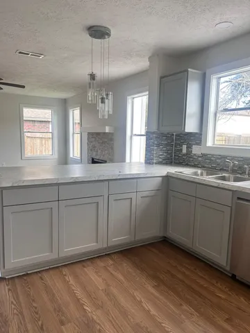 a kitchen with a sink cabinets and window